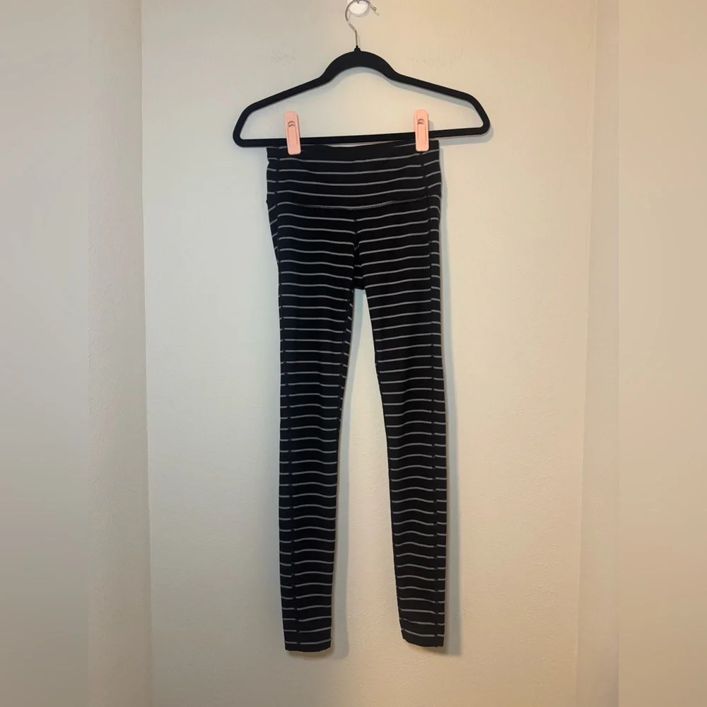Athleta Chaturanga tight leggings in a black and gray striped pattern